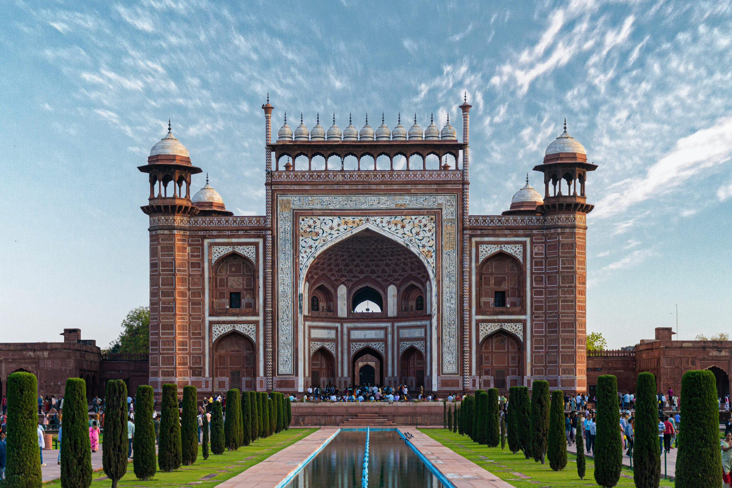 Beautiful view of the entrance gate to the iconic Taj Mahal, capturing its intricate architecture in Agra, India.