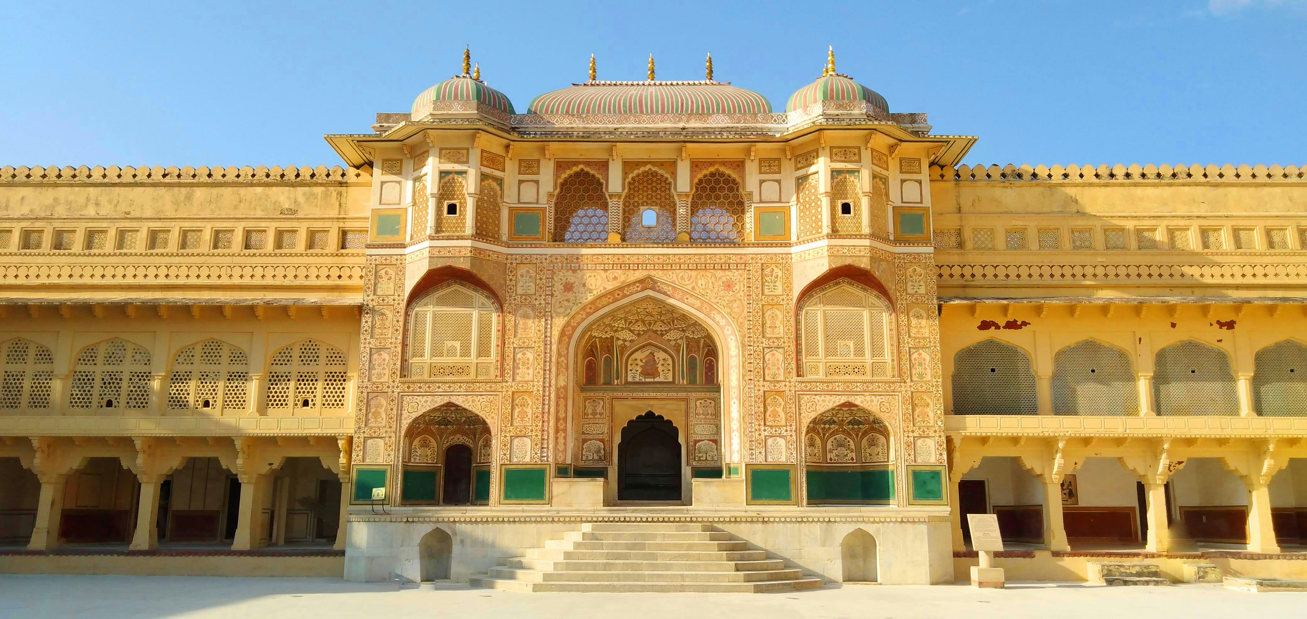 Stunning view of Amber Fort's intricate facade under a clear blue sky in Jaipur, India.