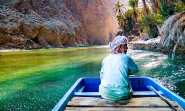 Wadi Shab Man with Boat 935x543