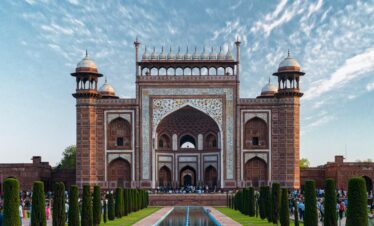 Beautiful view of the entrance gate to the iconic Taj Mahal, capturing its intricate architecture in Agra, India.